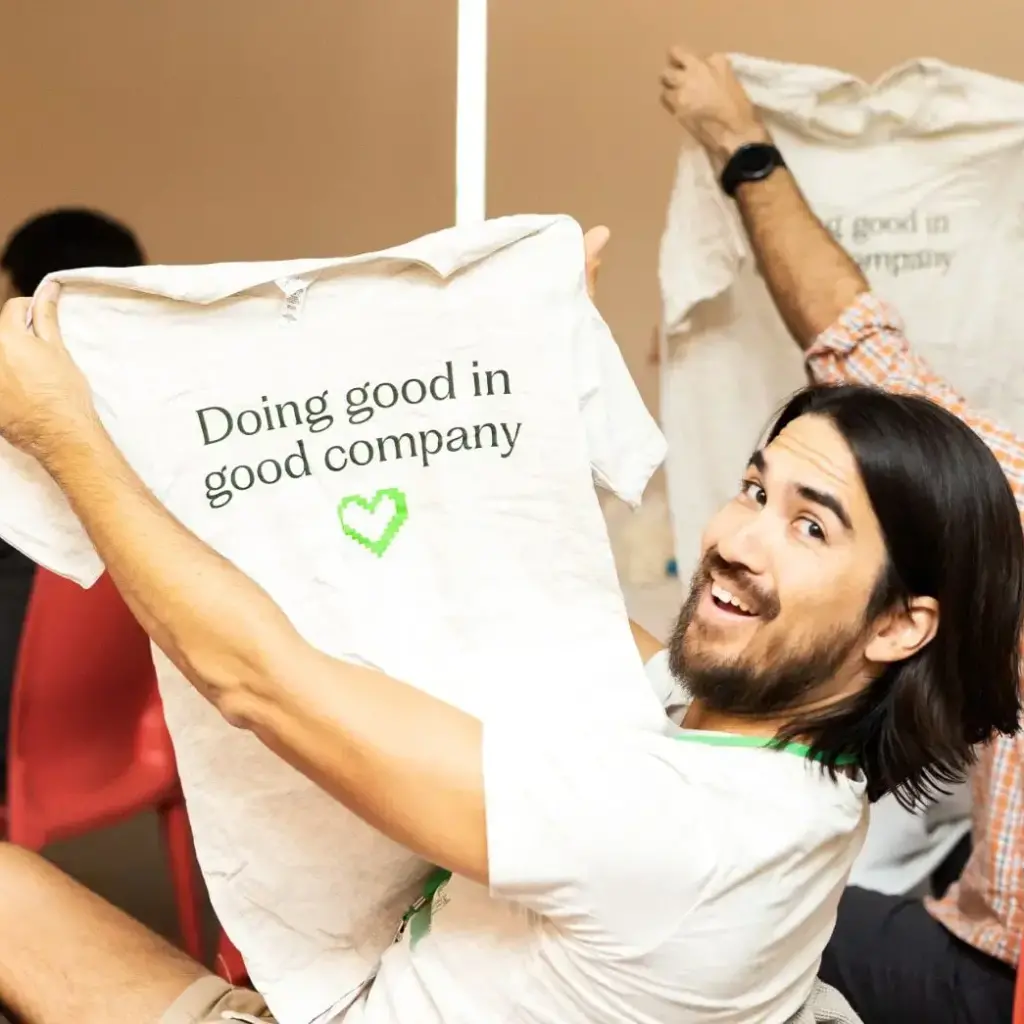Web Chef holding a T-shirt that reads 'Doing good in good company'